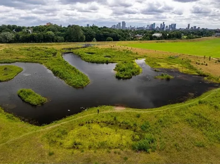 Framed Print : Aerial view of a newly created Kersal wetland park with Manchester city skyline in the background Framed Print : Aerial view of a newly created Kersal wetland park with Manchester city skyline in the background