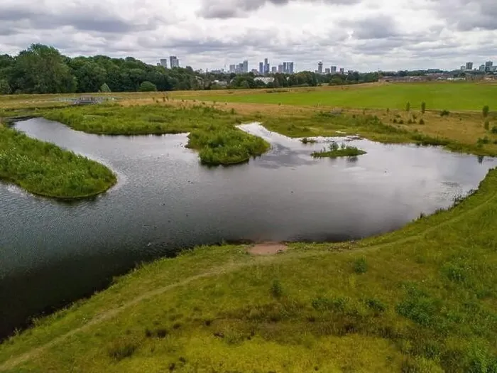Framed Print : Aerial view of a newly created Kersal wetland park with Manchester city skyline in the background Framed Print : Aerial view of a newly created Kersal wetland park with Manchester city skyline in the background
