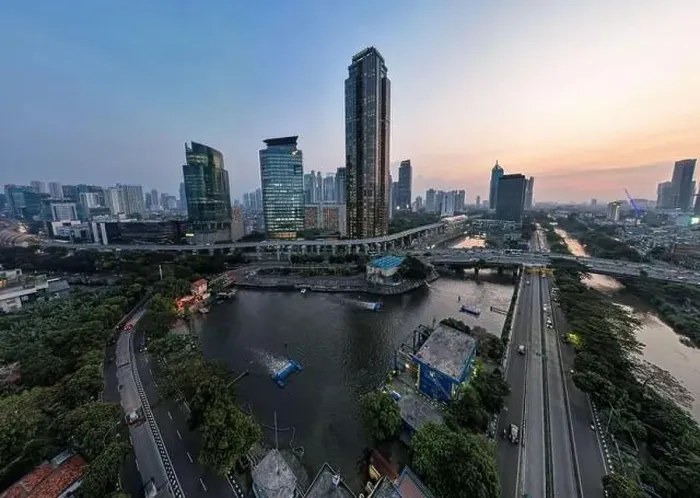 Framed Print : Aerial view of office buildings in Jakarta central business district and noise cloud when sunset Framed Print : Aerial view of office buildings in Jakarta central business district and noise cloud when sunset