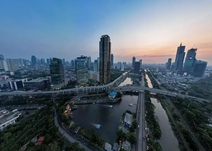 Framed Print : Aerial view of office buildings in Jakarta central business district and noise cloud when sunset Framed Print : Aerial view of office buildings in Jakarta central business district and noise cloud when sunset