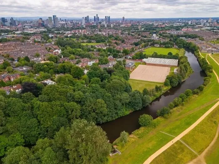Framed Print : Aerial view of a park in Salford with a river Irwell, buildings, and a city of Manchester skyline in the background Framed Print : Aerial view of a park in Salford with a river Irwell, buildings, and a city of Manchester skyline in the background