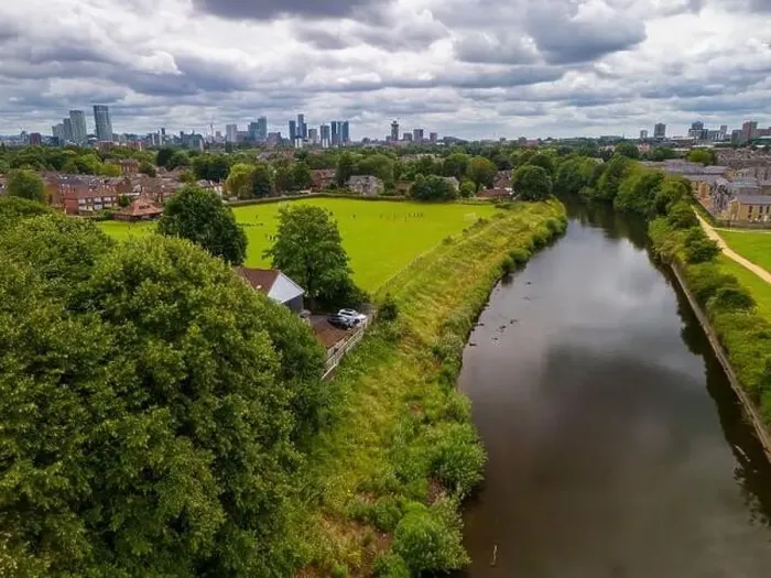 Framed Print : Aerial view of a park in Salford with a river Irwell, buildings, and a city of Manchester skyline in the background Framed Print : Aerial view of a park in Salford with a river Irwell, buildings, and a city of Manchester skyline in the background