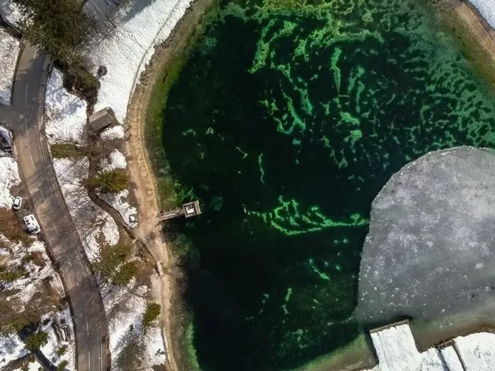 Framed Print : Aerial view of person swimming in icy man-made lake in Slovenia. Snowy lakeside Framed Print : Aerial view of person swimming in icy man-made lake in Slovenia. Snowy lakeside