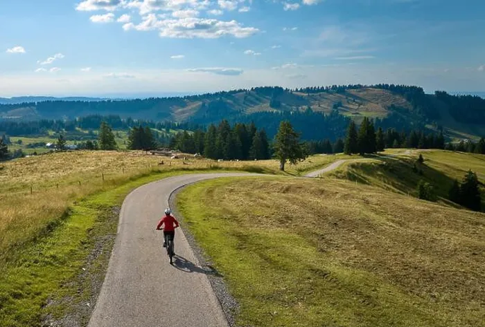 Framed Print : aerial view of a pretty mid age woman riding her electric mountain bike in the Allgau mountains near Framed Print : aerial view of a pretty mid age woman riding her electric mountain bike in the Allgau mountains near