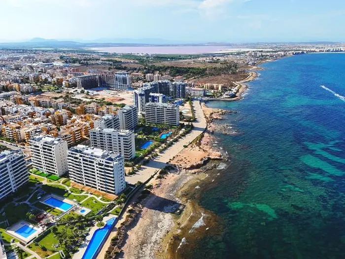 Framed Print : Aerial view of Punta Prima coastline with modern high-rise residential building. Costa Blanca, Alicante province. Spain Framed Print : Aerial view of Punta Prima coastline with modern high-rise residential building. Costa Blanca, Alicante province. Spain