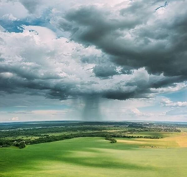 Aerial View Of Rain Above Countryside Rural Field Or Meadow Landscape With Green Grass Under Scenic Spring Dramatic Sky With White Fluffy Clouds. Rain