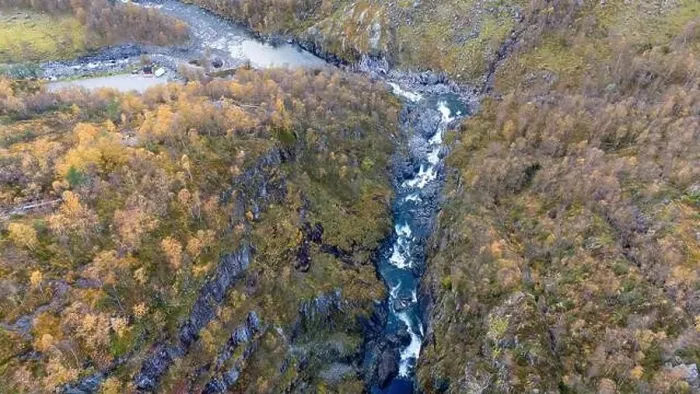 Framed Print : Aerial view of a river flowing through a rugged canyon surrounded by autumn foliage Framed Print : Aerial view of a river flowing through a rugged canyon surrounded by autumn foliage