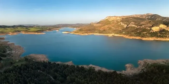Framed Print : Aerial view of river water flowing from Guadalhorce Dam of Gobantes Spain against rocky mountainous terrain under blue Framed Print : Aerial view of river water flowing from Guadalhorce Dam of Gobantes Spain against rocky mountainous terrain under blue