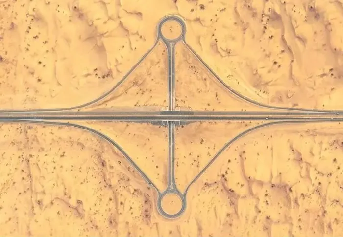 Framed Print : Aerial view of a road and roundabout crossing in the middle of a sandy desert in afternoon light Framed Print : Aerial view of a road and roundabout crossing in the middle of a sandy desert in afternoon light