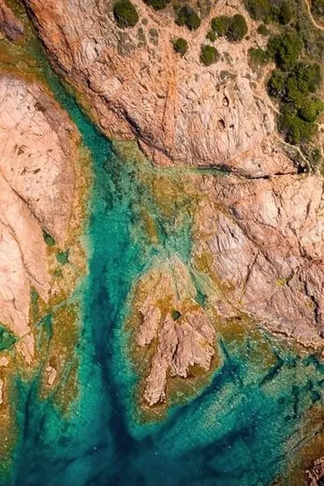 Framed Print : From above aerial view of a rocky coastline with turquoise waters and scattered vegetation in Sardinia, Italy Framed Print : From above aerial view of a rocky coastline with turquoise waters and scattered vegetation in Sardinia, Italy