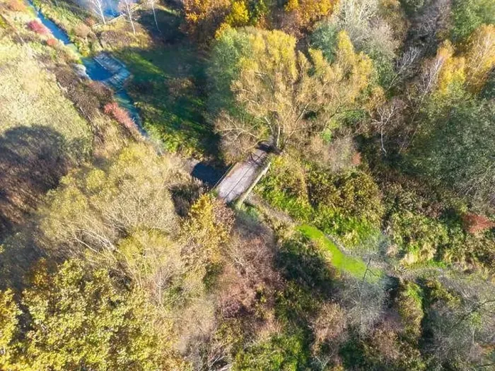 Framed Print : Aerial view of a rural road with in yellow and orange autumn forest Framed Print : Aerial view of a rural road with in yellow and orange autumn forest