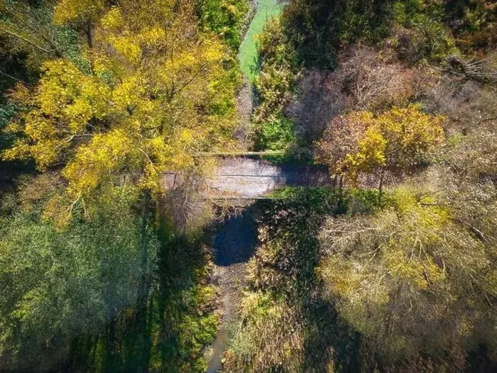 Framed Print : Aerial view of a rural road with in yellow and orange autumn forest Framed Print : Aerial view of a rural road with in yellow and orange autumn forest