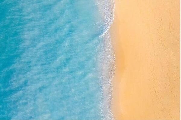 Aerial view of sandy beach and ocean nature with waves. Beach and waves from top view. Turquoise water background. Summer seascape from air. Aerial