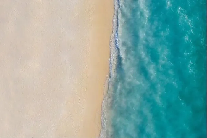 Framed Print : Aerial view of sandy beach and ocean with waves. Beautiful tropical white empty beach and sea waves seen from above. Beautiful sea landscape beach Framed Print : Aerial view of sandy beach and ocean with waves. Beautiful tropical white empty beach and sea waves seen from above. Beautiful sea landscape beach