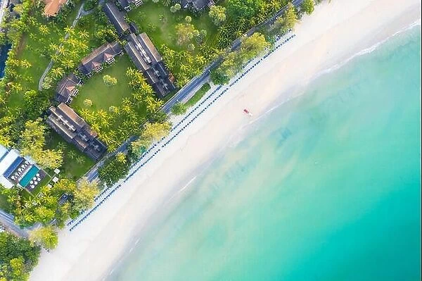Aerial view of sandy beach with tourists swimming in beautiful clear sea water in Phuket, Thailand