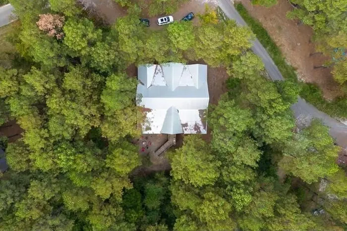 Framed Print : Aerial view of secluded cottage in the woods among green trees Framed Print : Aerial view of secluded cottage in the woods among green trees