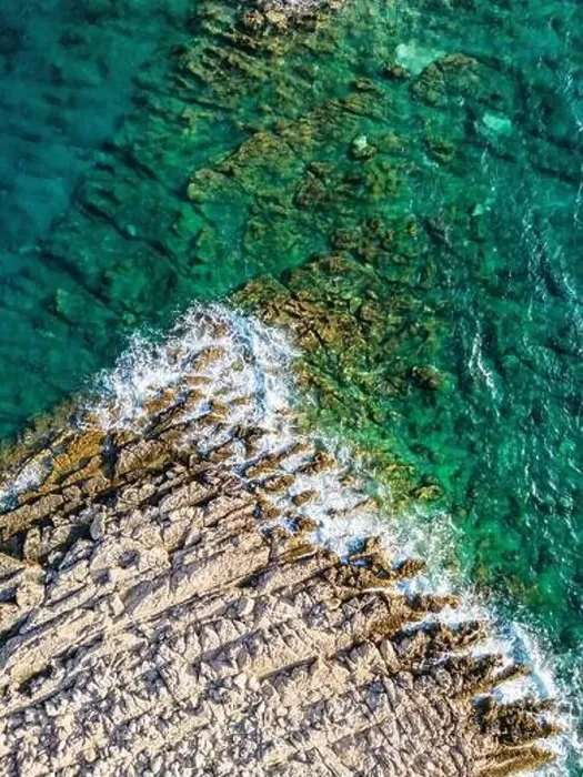 Framed Print : Aerial view of sharp rocks on Punta Planka, Croatia, splashed with waves creating white foam Framed Print : Aerial view of sharp rocks on Punta Planka, Croatia, splashed with waves creating white foam