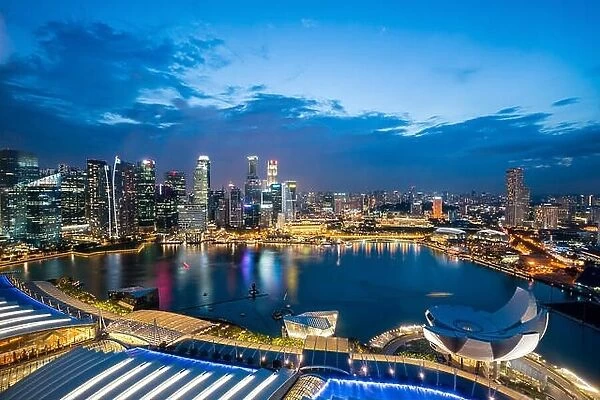 Aerial view of Singapore business district skyline with tourist sightseeing in night at Marina Bay, Singapore. Asian tourism, modern city life, or bus