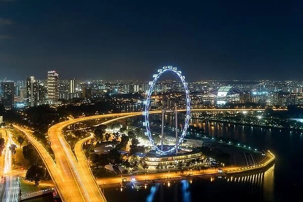 Aerial view of Singapore flyer and city at night in Singapore, Asia