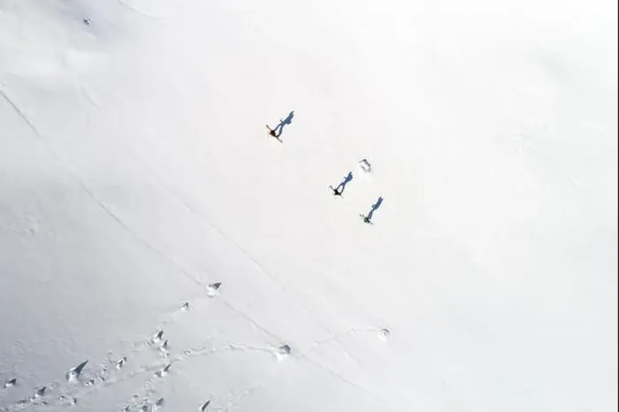 Framed Print : Aerial view of three skiers and their shadows in the Alps, Sportgastein, Salzburg, Austria