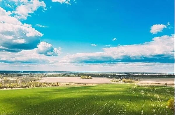 Aerial View. Sky With Clouds Above Countryside Rural Field Landscape In Spring Summer Cloudy Day. Scenic Sky With Fluffy Clouds On Horizon. Beauty In
