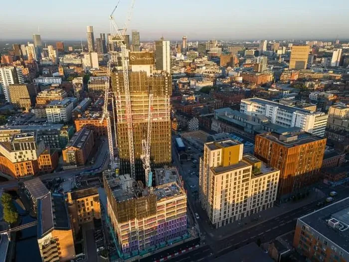 Framed Print : Aerial view of a skyscraper under construction on Ancoats area, Manchester UK Framed Print : Aerial view of a skyscraper under construction on Ancoats area, Manchester UK