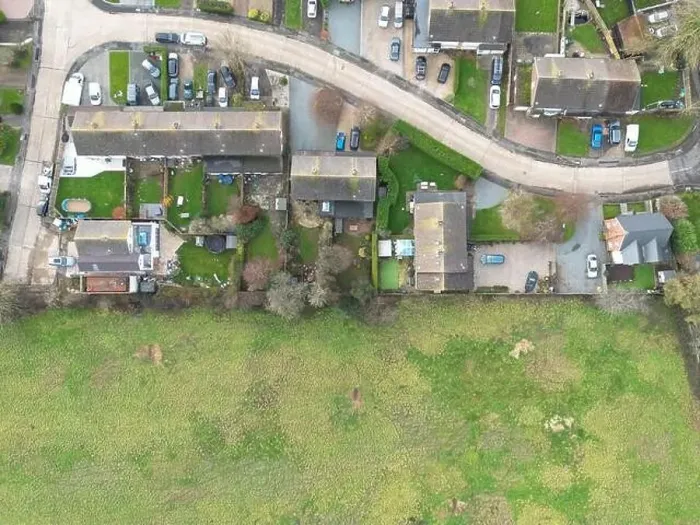 Framed Print : Aerial view of a small rural housing estate in the UK. The adjacent field may soon be developed on for my housing Framed Print : Aerial view of a small rural housing estate in the UK. The adjacent field may soon be developed on for my housing