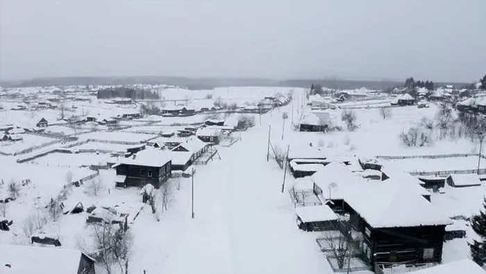 Framed Print : Aerial view of snow covered roofs of wooden houses. Clip. Small winter village on a heavy cloudy sky background Framed Print : Aerial view of snow covered roofs of wooden houses. Clip. Small winter village on a heavy cloudy sky background