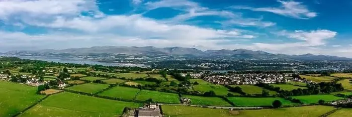 Framed Print : Aerial view of snowdonia landscape in the distance from Anglesey Framed Print : Aerial view of snowdonia landscape in the distance from Anglesey