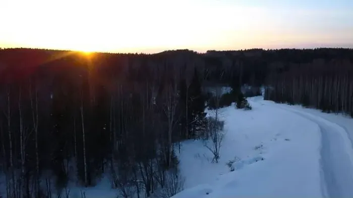 Framed Print : Aerial view of a snowmobile driving along pine tree forest. Clip. Sunset sky and rural snow covered road Framed Print : Aerial view of a snowmobile driving along pine tree forest. Clip. Sunset sky and rural snow covered road