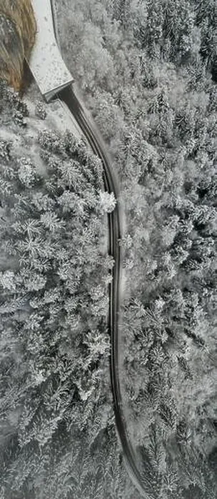 Framed Print : Aerial view of snowy forest with a road. Captured from above with a drone Framed Print : Aerial view of snowy forest with a road. Captured from above with a drone