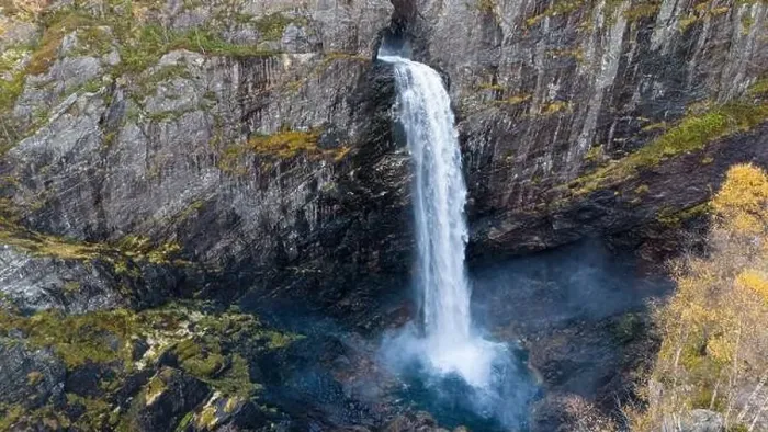 Framed Print : Aerial view of a stunning waterfall cascading down rocky cliffs into a deep blue pool surrounded by lush greenery Framed Print : Aerial view of a stunning waterfall cascading down rocky cliffs into a deep blue pool surrounded by lush greenery