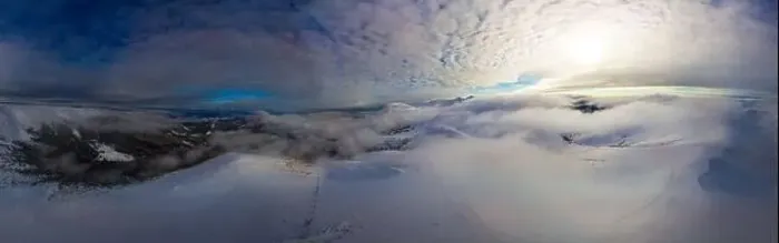 Framed Print : Aerial view of the stunning winter panorama of the snowy slopes and hills among the lush white clouds Framed Print : Aerial view of the stunning winter panorama of the snowy slopes and hills among the lush white clouds