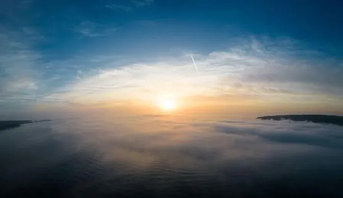 Framed Print : Aerial view of a sunrise sea with a blanket of morning fog and morning sunbeams shining through Framed Print : Aerial view of a sunrise sea with a blanket of morning fog and morning sunbeams shining through