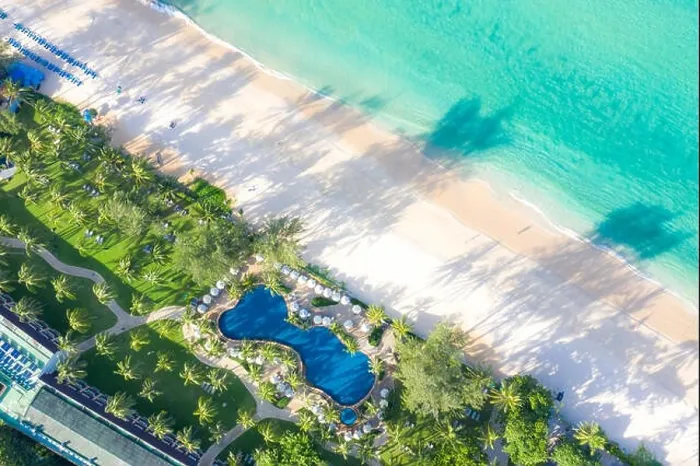 Framed Print : Aerial view of swimming pool with sea and beach in luxury hotel and resort for travel and vacation