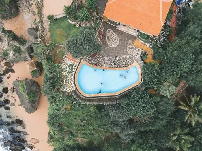 Framed Print : Top aerial view of swimming pool in villa near beach