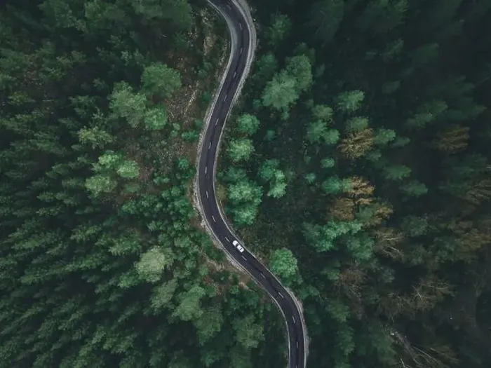 Framed Print : Aerial view taken by drone of a car driving on a forest road in autumn Framed Print : Aerial view taken by drone of a car driving on a forest road in autumn