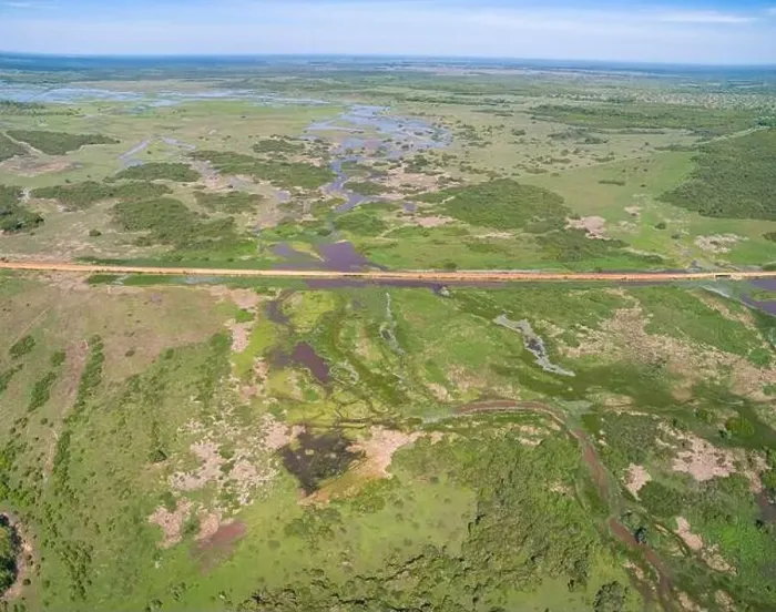 Framed Print : Aerial view of Transpantaneira dirt road crossing a lagoon over a small bridge in the typical landscape of North Framed Print : Aerial view of Transpantaneira dirt road crossing a lagoon over a small bridge in the typical landscape of North
