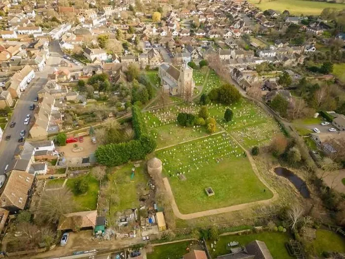 Framed Print : Aerial view of a typical English village with the old Church seen at the centre of the village with its large cemetery Framed Print : Aerial view of a typical English village with the old Church seen at the centre of the village with its large cemetery
