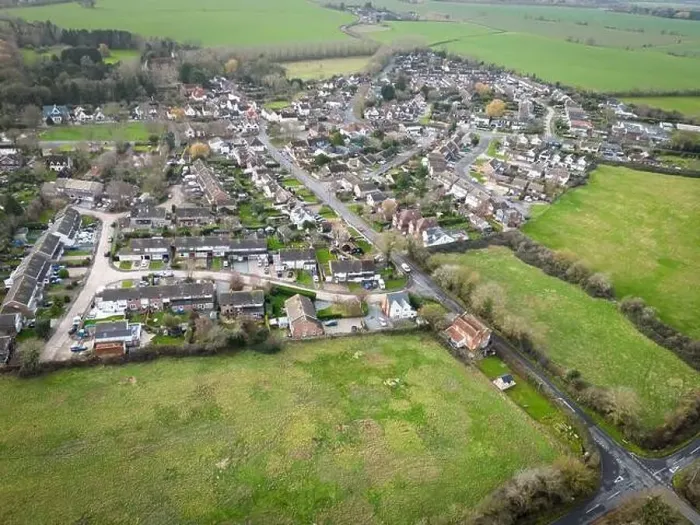 Framed Print : Aerial view of a typical English village showing housing development expansion over the years Framed Print : Aerial view of a typical English village showing housing development expansion over the years