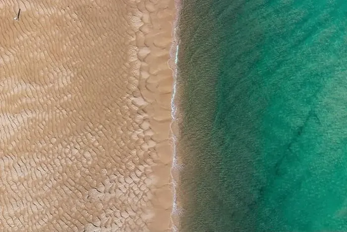 Framed Print : Aerial top view of unrecognizable traveler walking along turquoise ocean washing sandy beach with rippled sand on sunny Framed Print : Aerial top view of unrecognizable traveler walking along turquoise ocean washing sandy beach with rippled sand on sunny