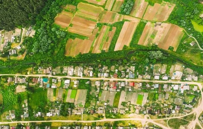 Framed Print : Aerial View Of Vegetable Gardens In Small Town Or Village. Skyline In Summer Evening. Village Garden Beds In Bird's-eye View Framed Print : Aerial View Of Vegetable Gardens In Small Town Or Village. Skyline In Summer Evening. Village Garden Beds In Bird's-eye View