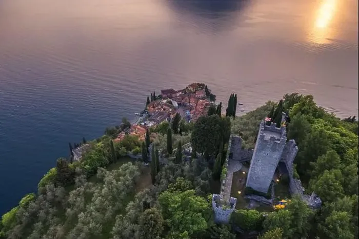 Framed Print : Aerial view of Vezio Castle and Varenna village in background during summer sunset Framed Print : Aerial view of Vezio Castle and Varenna village in background during summer sunset