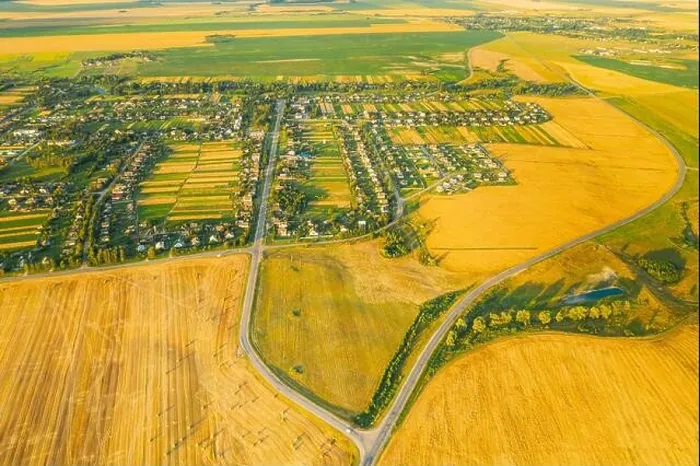 Framed Print : Aerial View Of Village And Hay Rolls, Straw Field Landscape In Summer Evening. Haystack, Hay Roll in Sunrise Time. Agricultural Countryside landscape Framed Print : Aerial View Of Village And Hay Rolls, Straw Field Landscape In Summer Evening. Haystack, Hay Roll in Sunrise Time. Agricultural Countryside landscape