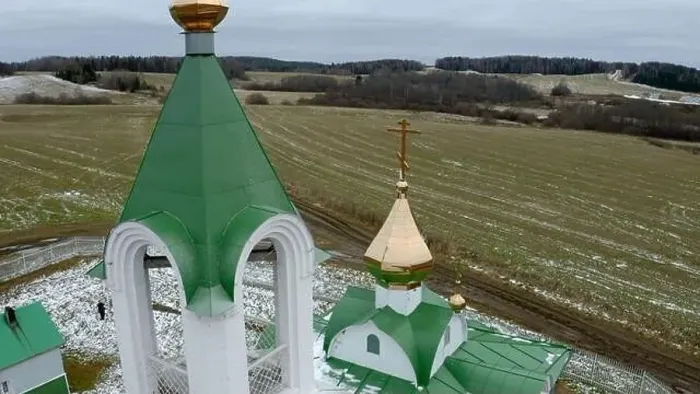 Framed Print : Aerial view of a white and green church with a golden cross and bell. Clip. Green field covered by snow Framed Print : Aerial view of a white and green church with a golden cross and bell. Clip. Green field covered by snow