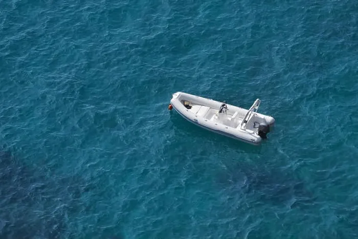 Framed Print : Aerial view of a white speed boat on a blue clear sea water Framed Print : Aerial view of a white speed boat on a blue clear sea water