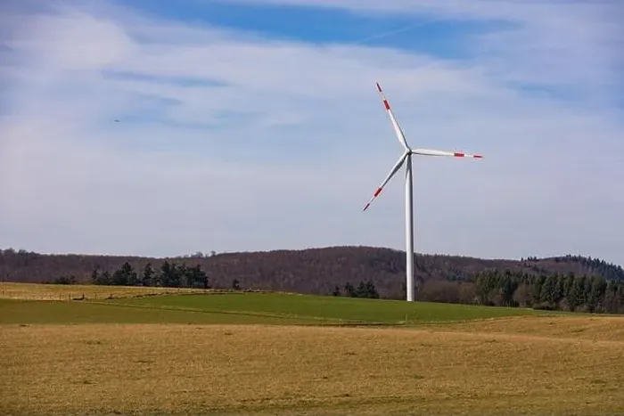 Framed Print : Aerial view of a wind turbine with red and white rotor blades in a rural landscape Framed Print : Aerial view of a wind turbine with red and white rotor blades in a rural landscape