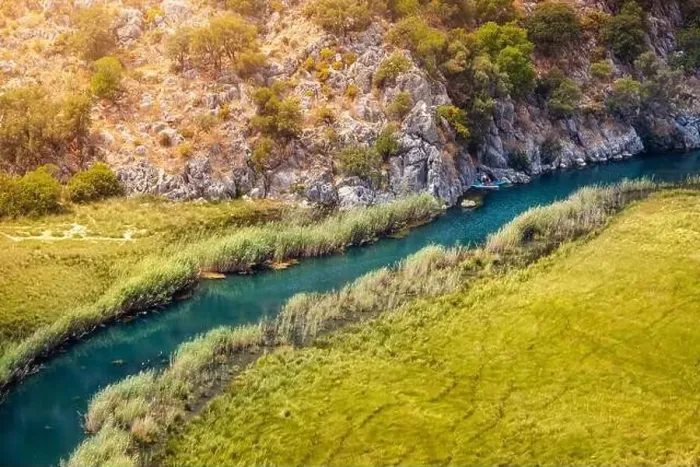 Framed Print : Aerial View of a winding river in the middle of a swampy area with a kayak traveling up the creek Framed Print : Aerial View of a winding river in the middle of a swampy area with a kayak traveling up the creek