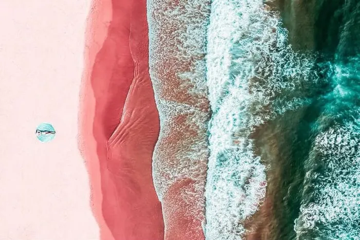 Framed Print : Aerial View Of Woman On Pink Ocean Beach Framed Print : Aerial View Of Woman On Pink Ocean Beach