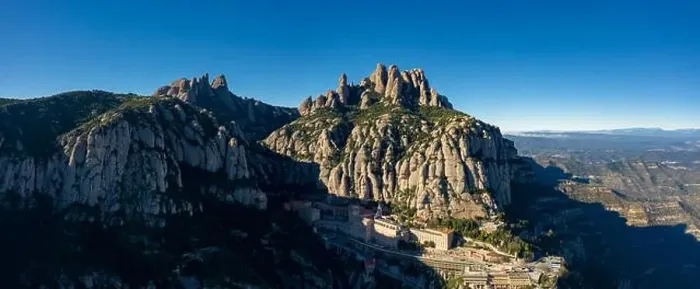 Framed Print : Aerial; wide panorama of famous abbey homonymous mountain range Montserrat; tourist attractions route of Spain; drone